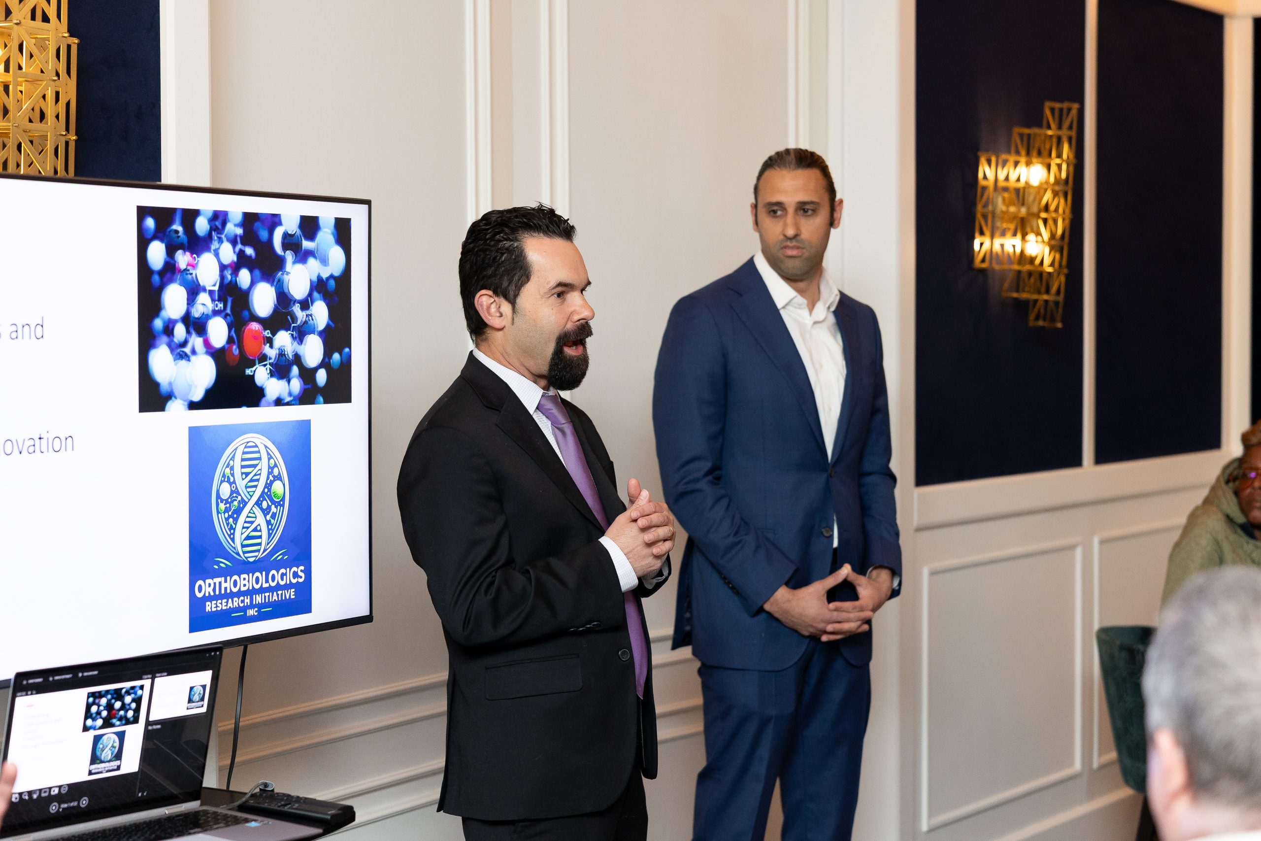 ROSM physicians talking at a fundraiser about regenerative medicine