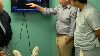 Dr. Sean Mulvaney reviewing ultrasound imaging during a stellate ganglion block procedure at ROSM