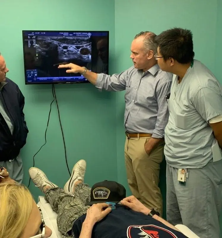 Dr. Sean Mulvaney reviewing ultrasound imaging during a stellate ganglion block procedure at ROSM